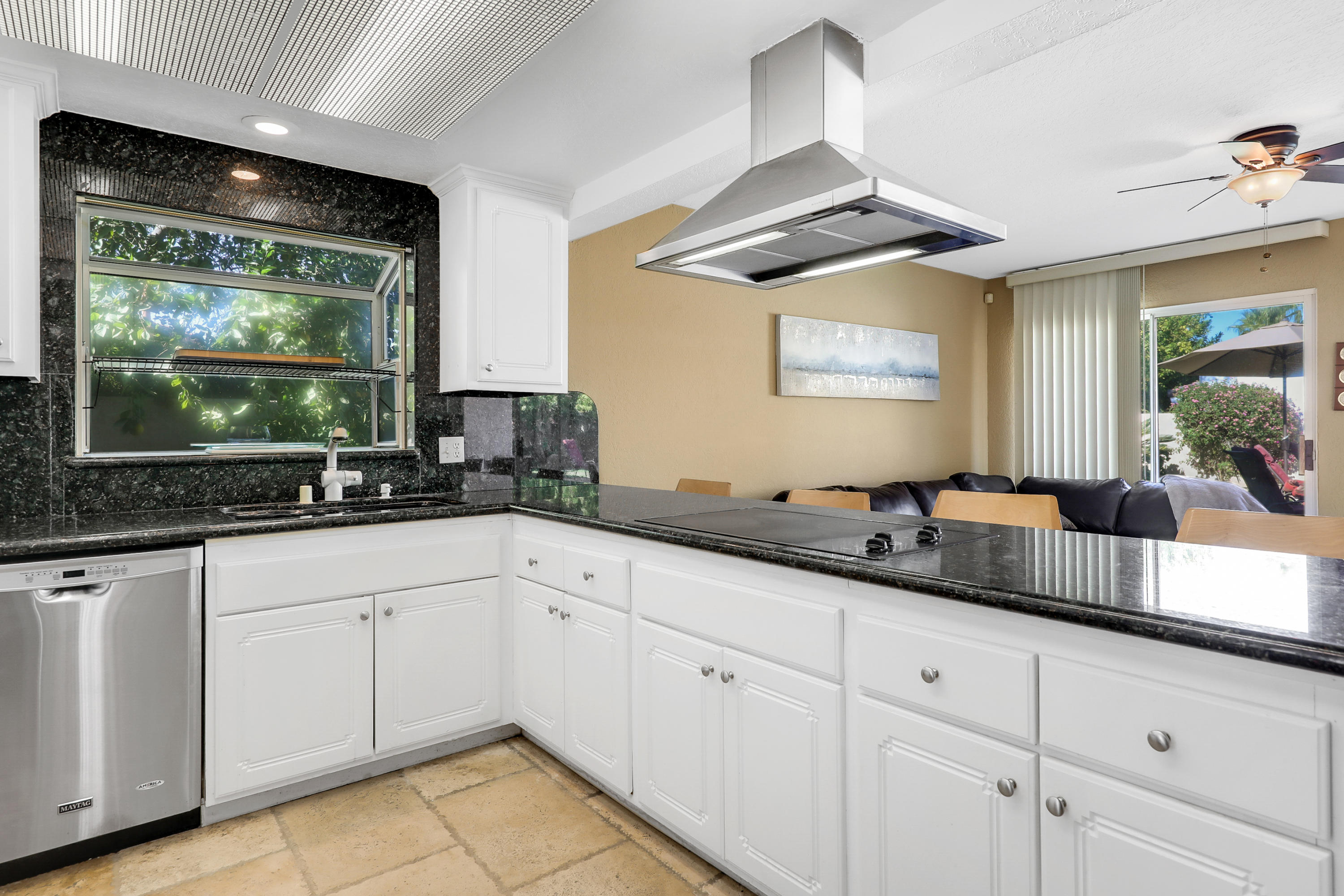 78950 Starlight Lane Bermuda Dunes, CA 92203 - Photo 9 of 32 a kitchen with granite countertop white cabinets white appliances and a wide window
