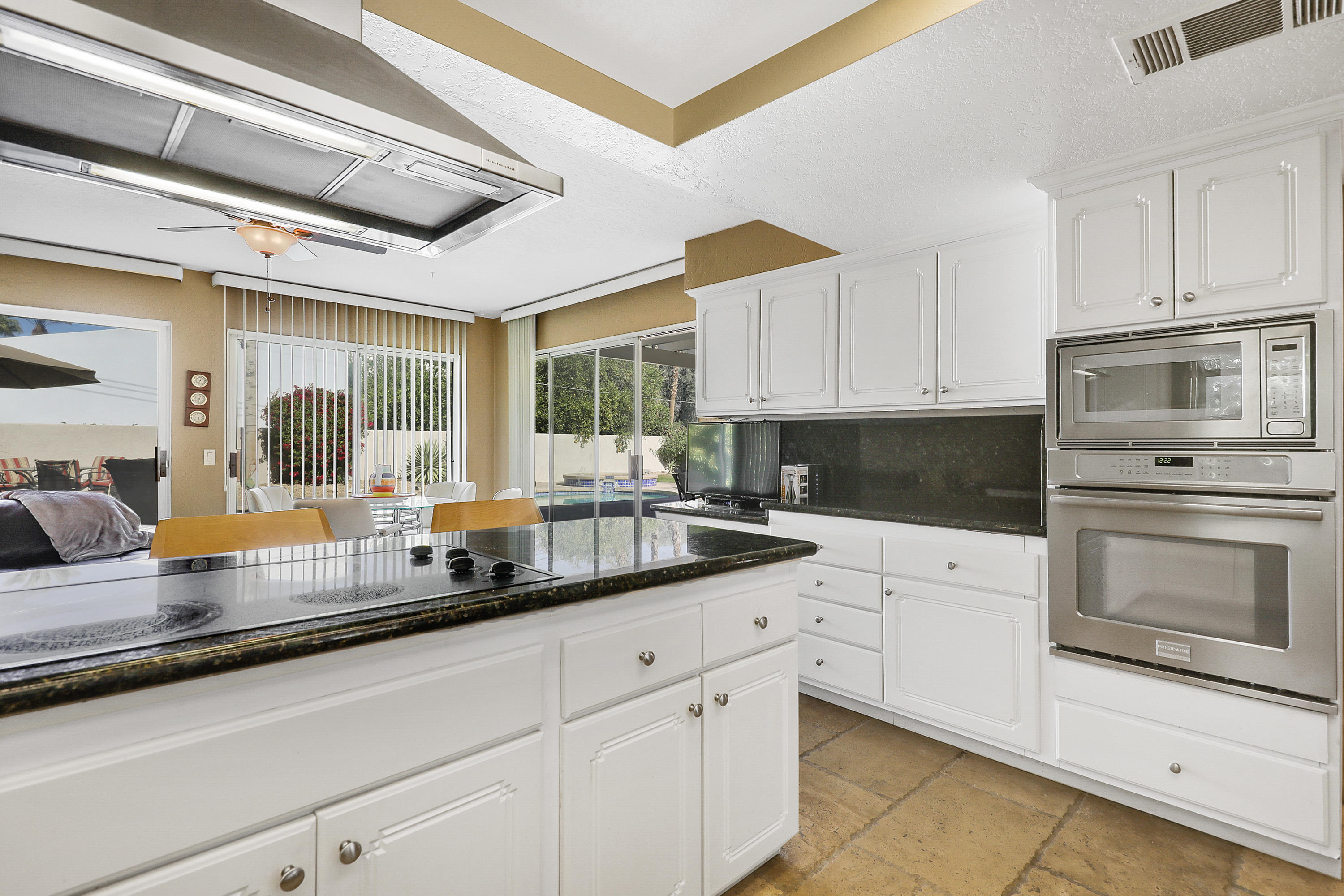 78950 Starlight Lane Bermuda Dunes, CA 92203 - Photo 10 of 32 a kitchen with white cabinets and appliances