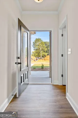 a view of empty room with window and front door