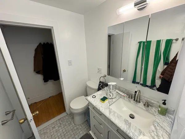 a white toilet sitting next to a bathroom sink and a shower