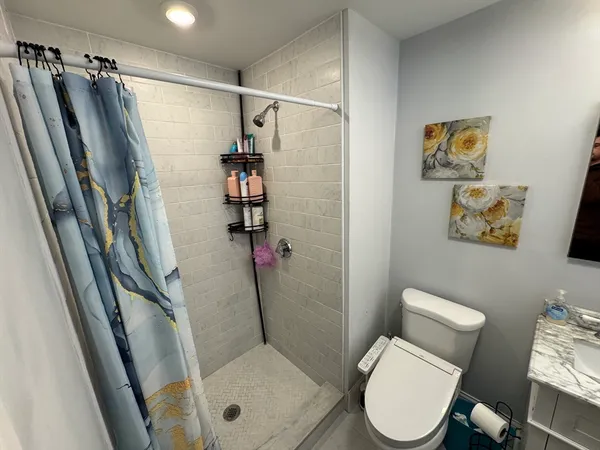 a bathroom with a sink toilet and mirror