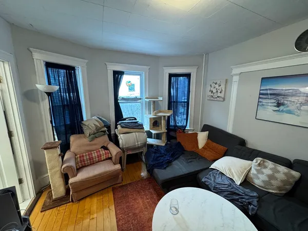 a living room with furniture and wooden floor
