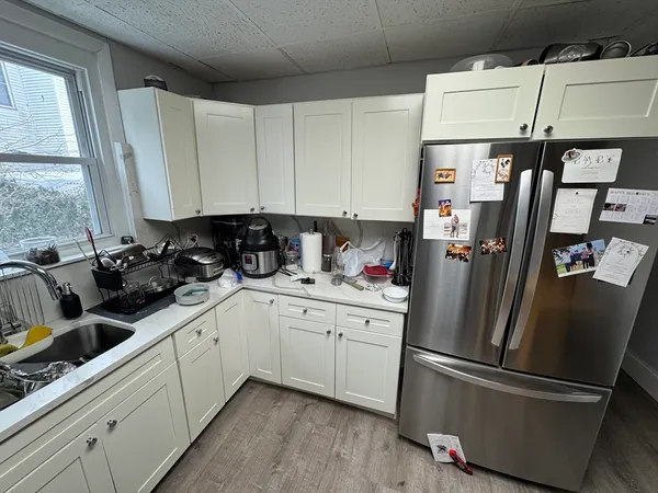 a kitchen with stainless steel appliances a refrigerator a sink a stove a microwave and cabinets