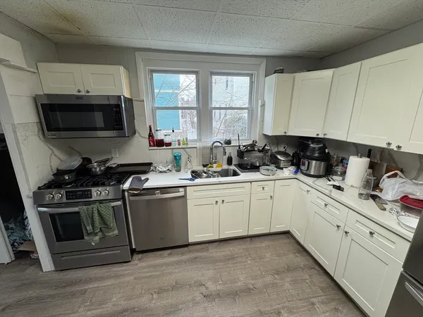 a kitchen with a sink stove and microwave