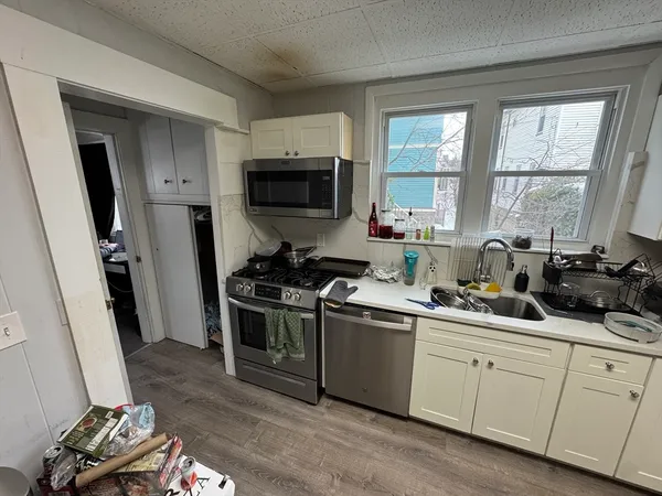 a kitchen with a sink stove and microwave