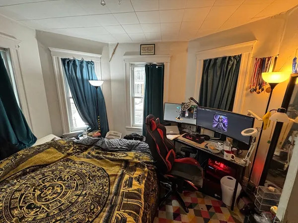 a bedroom with bed and a mirror