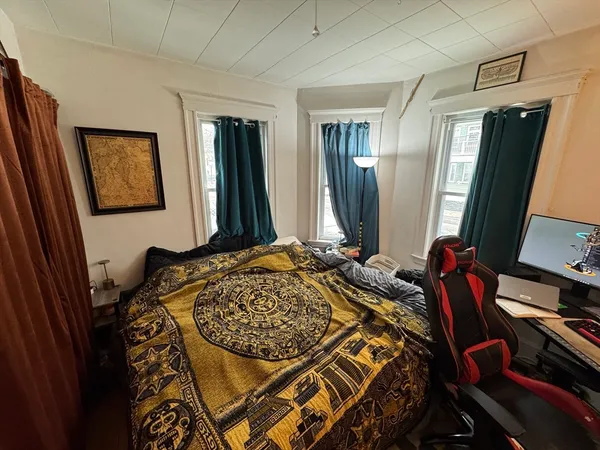 a bedroom with a bed and a mirror