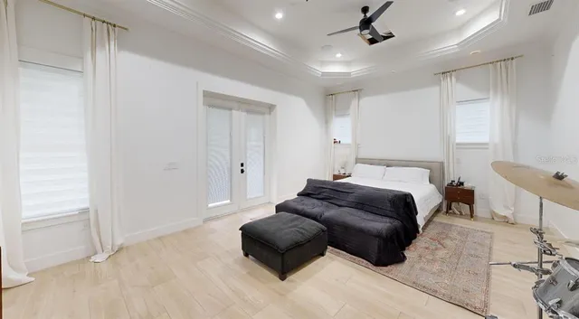 a bedroom with a bed window and couch