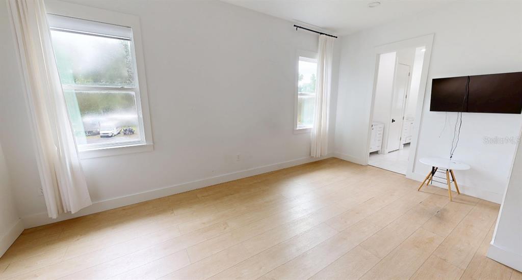 8241 Cass Road Zephyrhills, FL 33540 - Photo 17 of 25 a view of room with window and wooden floor