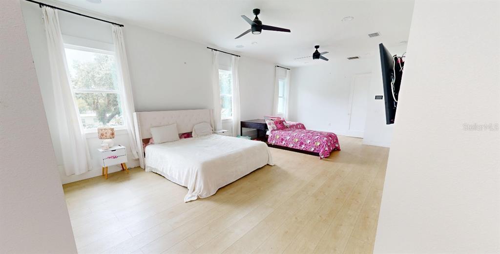 8241 Cass Road Zephyrhills, FL 33540 - Photo 18 of 25 a bedroom with a bed and a window