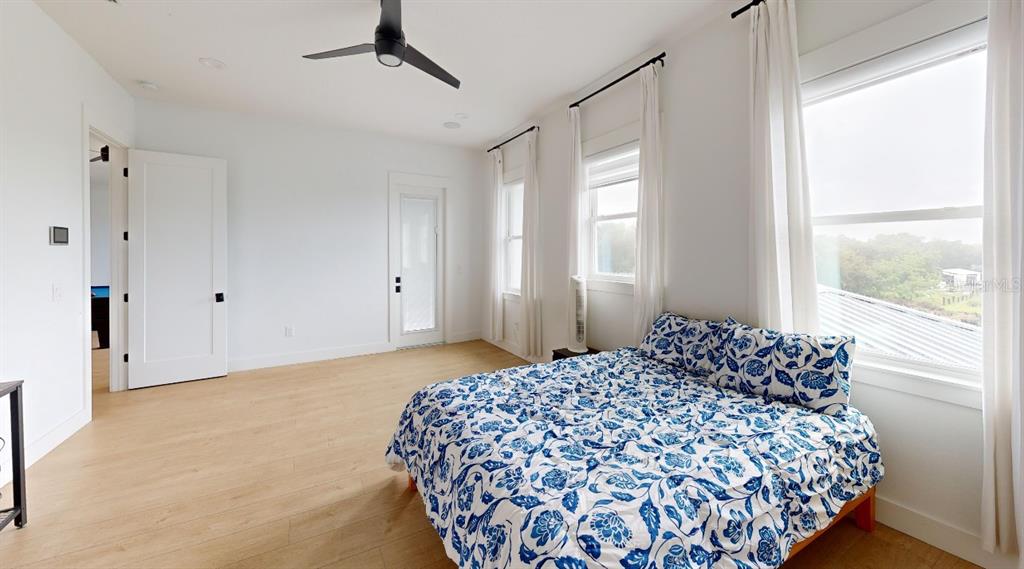 8241 Cass Road Zephyrhills, FL 33540 - Photo 20 of 25 a bedroom with a large bed and a window