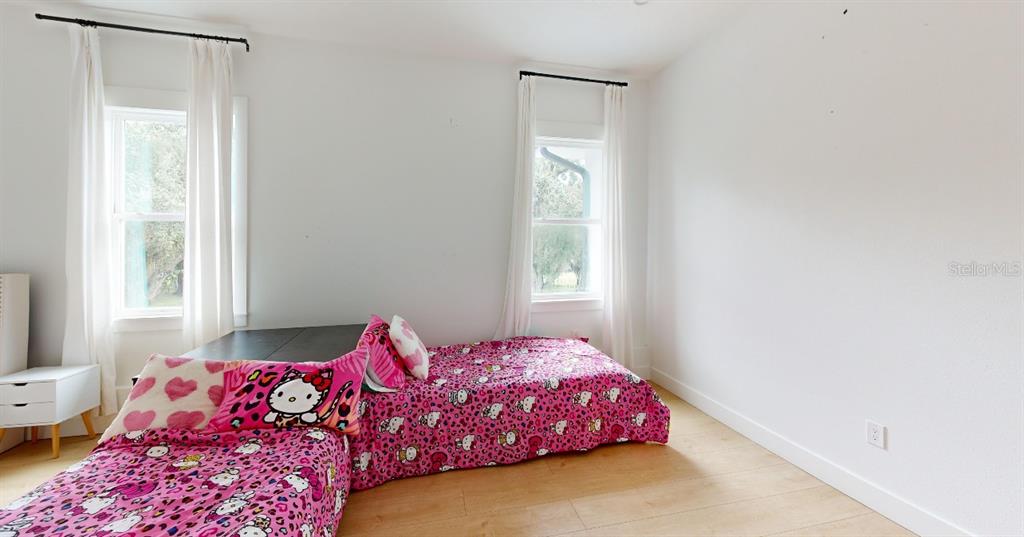 8241 Cass Road Zephyrhills, FL 33540 - Photo 22 of 25 a bedroom with a bed and a window