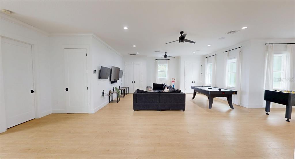 8241 Cass Road Zephyrhills, FL 33540 - Photo 23 of 25 a living room with furniture and wooden floor