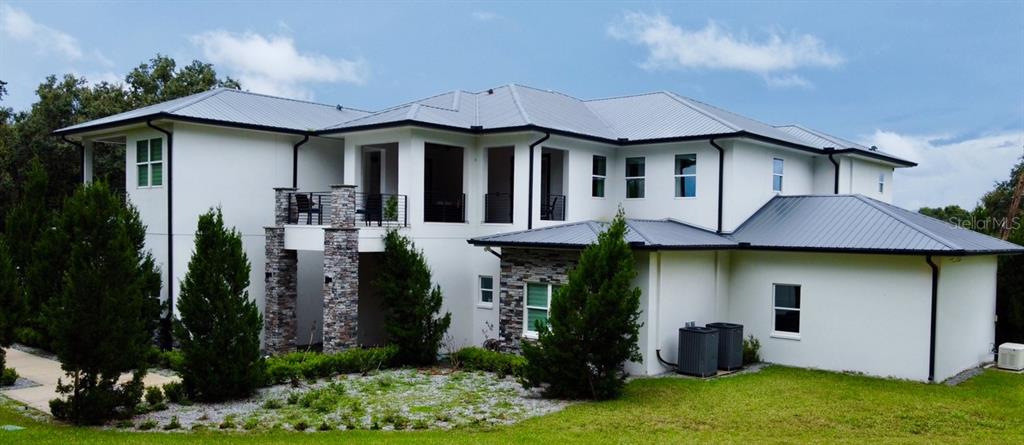 8241 Cass Road Zephyrhills, FL 33540 - Photo 24 of 25 a front view of a house with garden
