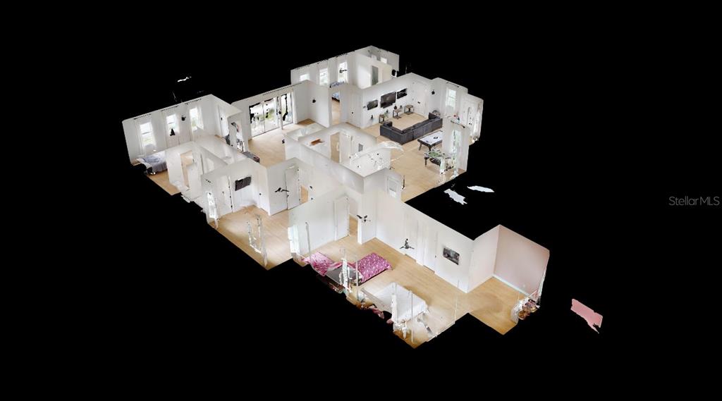 8241 Cass Road Zephyrhills, FL 33540 - Photo 25 of 25 a bed sitting in a bedroom next to a lamp