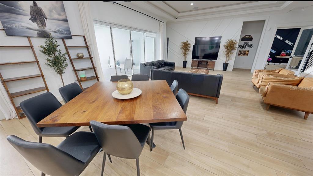 8241 Cass Road Zephyrhills, FL 33540 - Photo 5 of 25 a view of a dining room with furniture and wooden floor