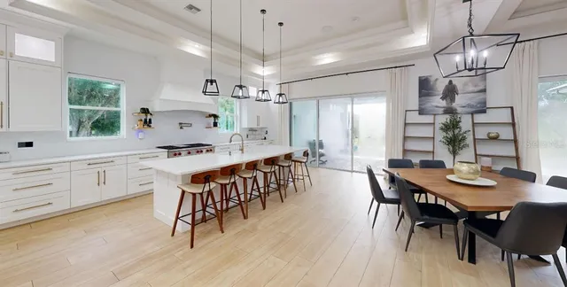 a large kitchen with a table and chairs