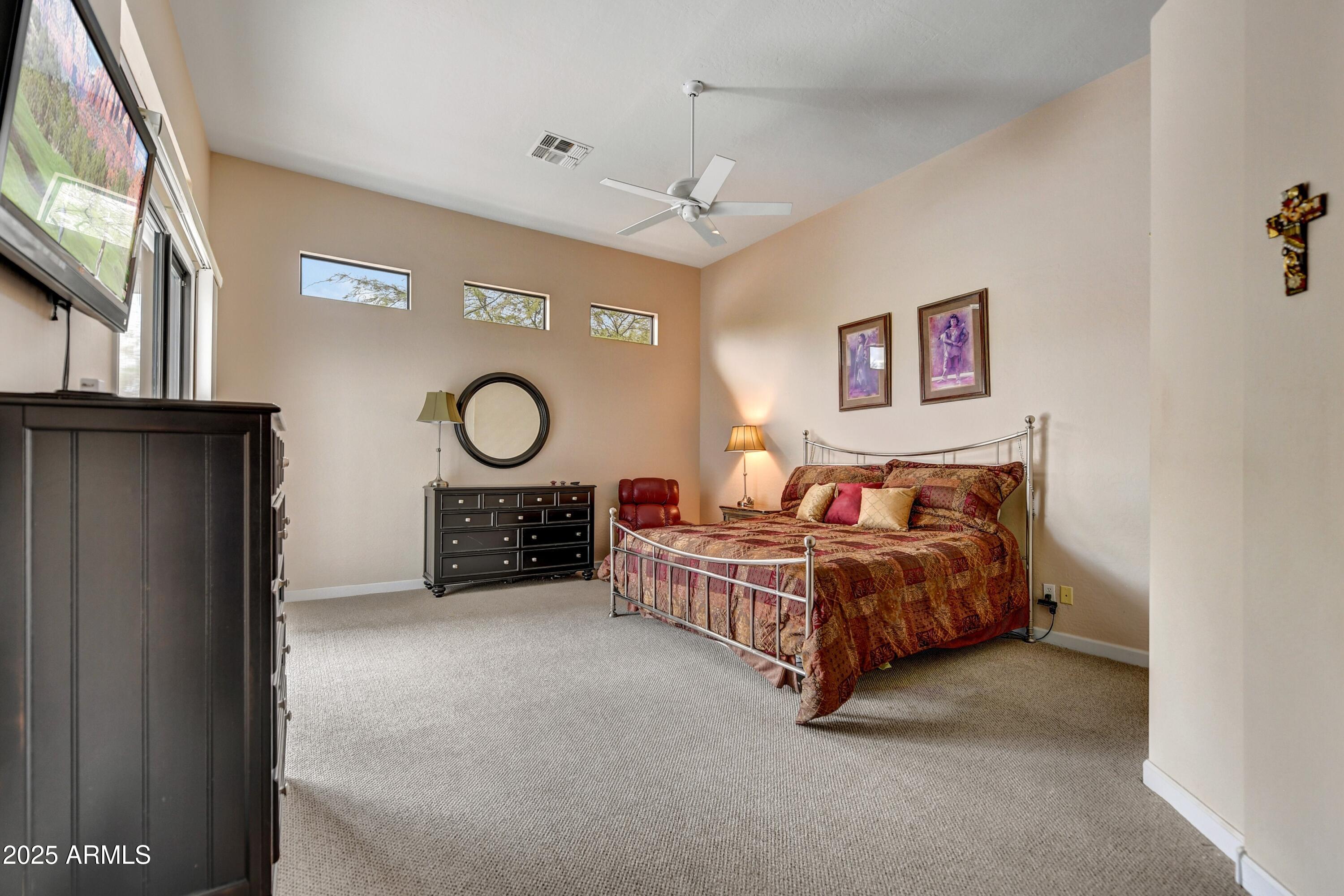 19057 East Alondra Way Rio Verde, AZ 85263 - Photo 10 of 21 a spacious bedroom with a bed couch and a window