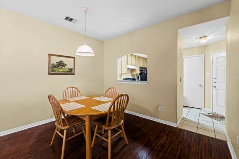 a view of a dining room with furniture and wooden floor