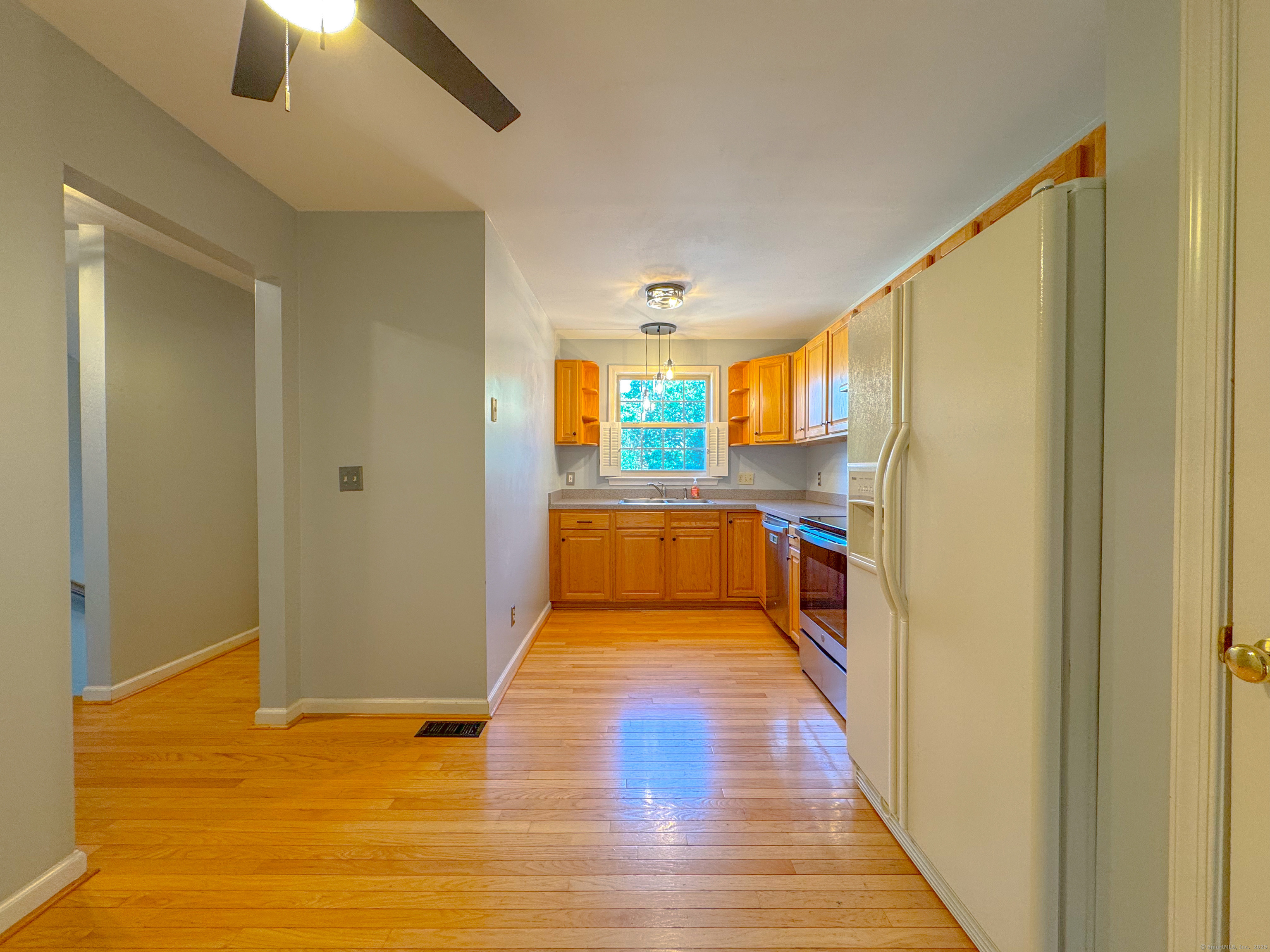 19 Hawthorne Drive, Unit 102 New London, CT 06320 - Photo 14 of 33 a view of a living room with kitchen view and wooden floor
