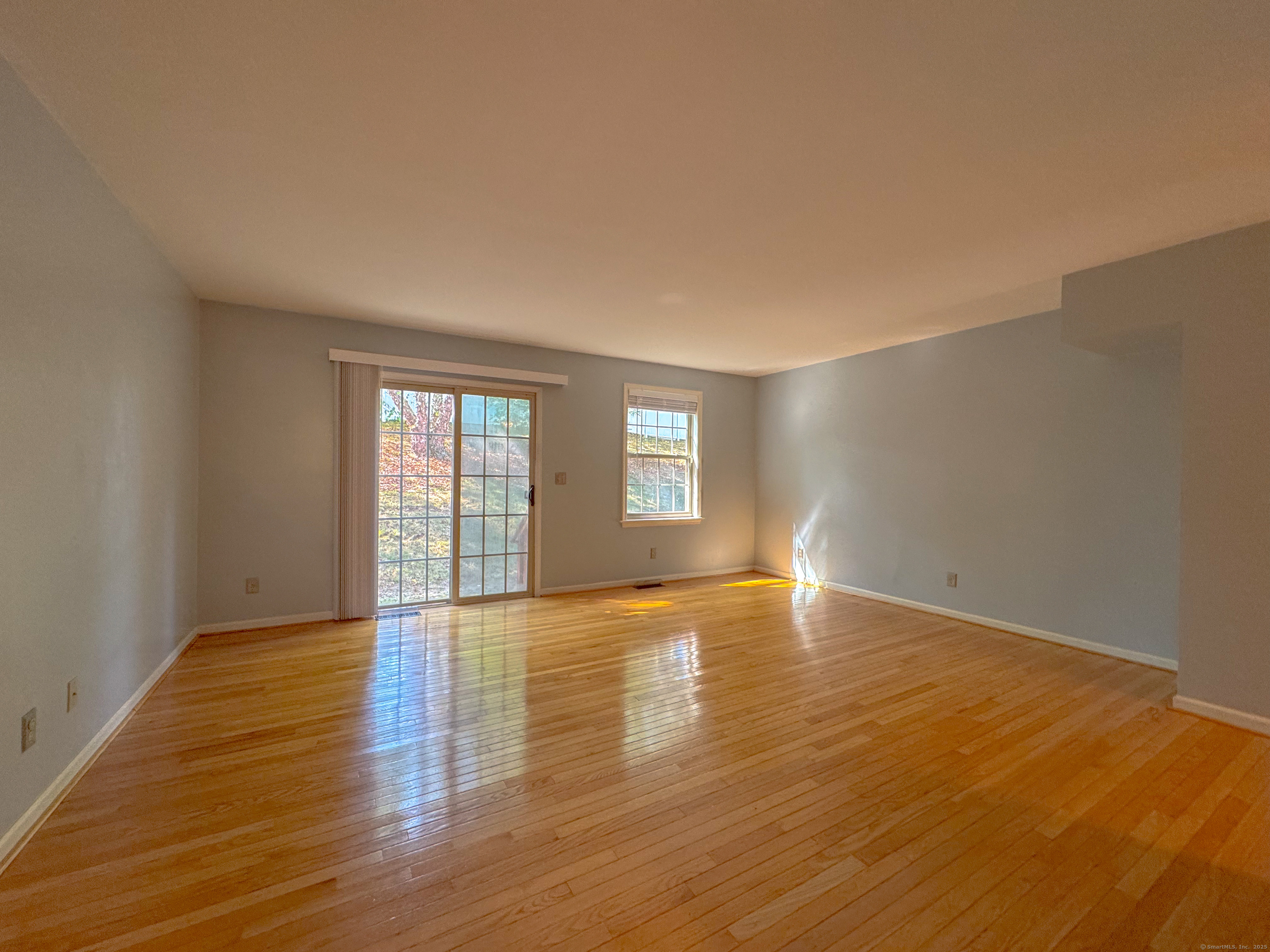 19 Hawthorne Drive, Unit 102 New London, CT 06320 - Photo 16 of 33 a view of an empty room with window and wooden floor