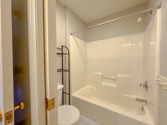 a bathroom with a shower and a toilet