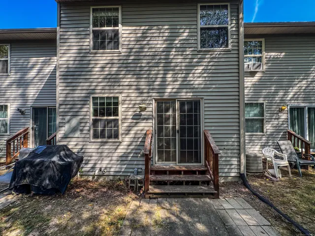 a view of a house with a door and a yard