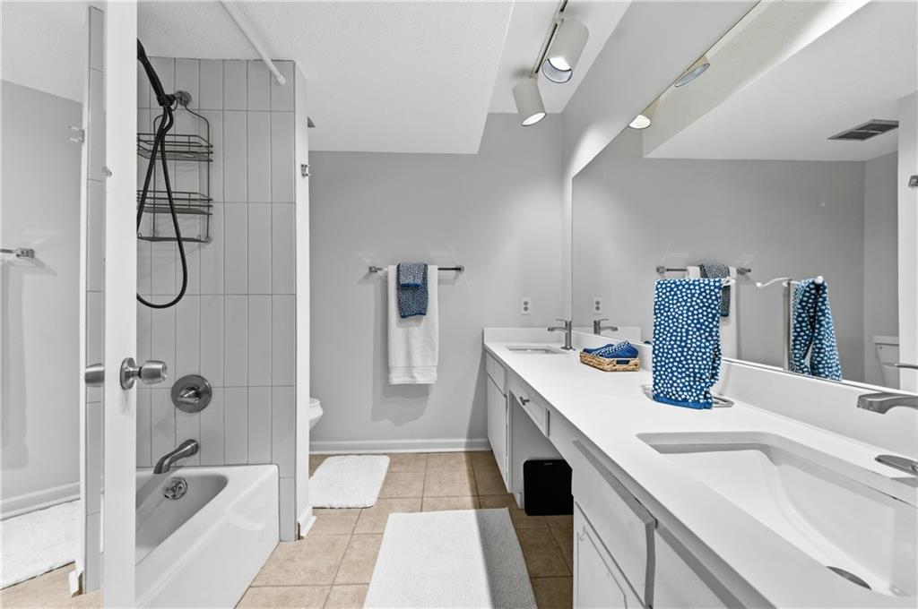 6851 Roswell Road, Unit F15 Atlanta, GA 30328 - Photo 14 of 31 a bathroom with a sink vanity granite tub shower and mirror