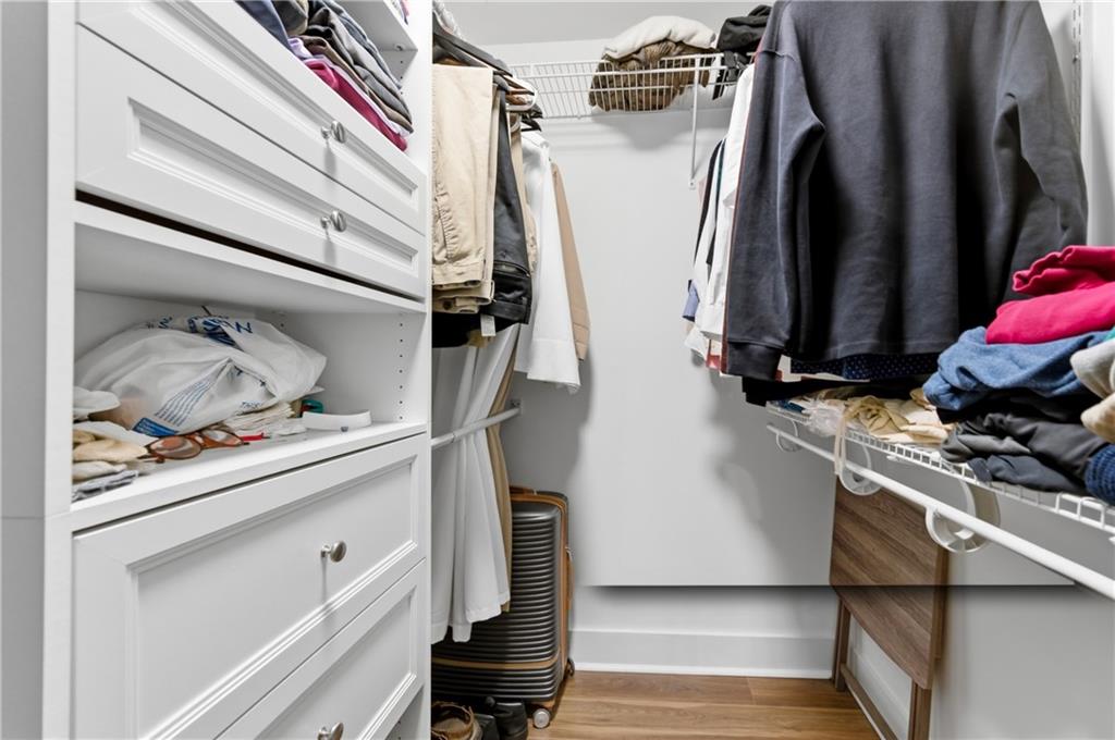 6851 Roswell Road, Unit F15 Atlanta, GA 30328 - Photo 16 of 31 a view of walk in closet with clothes and shoes