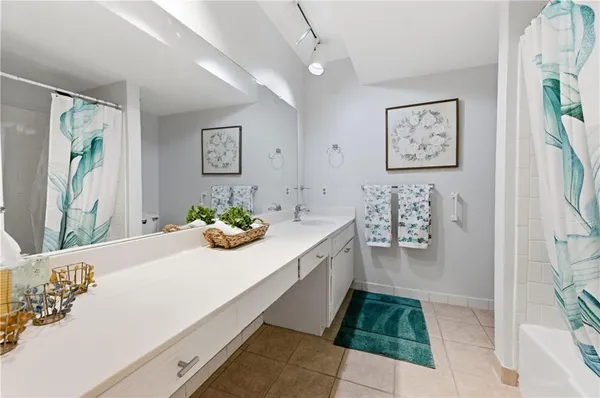 a bathroom with a bathtub sink and mirror