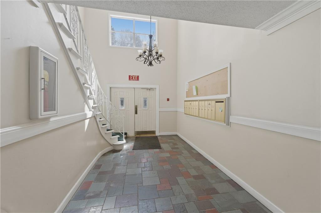 6851 Roswell Road, Unit F15 Atlanta, GA 30328 - Photo 28 of 31 a view of entryway with hallway and stairs