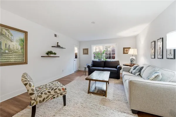 a living room with furniture and a potted plant
