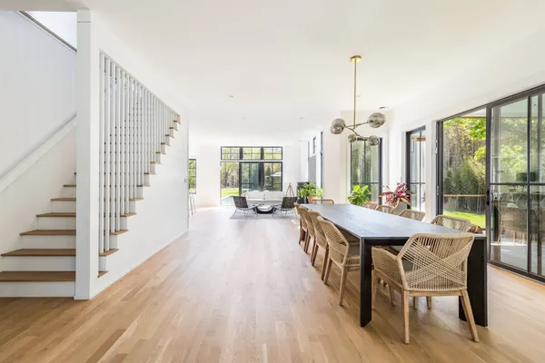 a view of a dining room with furniture window and wooden floor