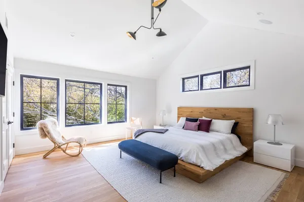 a spacious bedroom with a bed a couch and a window