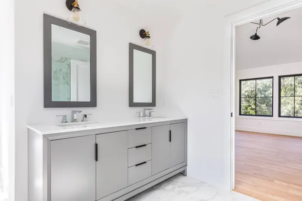 a bathroom with 2 sink and a mirror