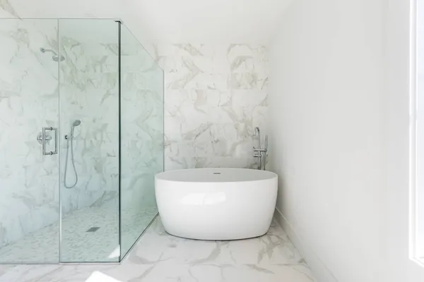 a white bath tub sitting next to a white sink