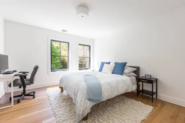 a bedroom with a bed a table and chair