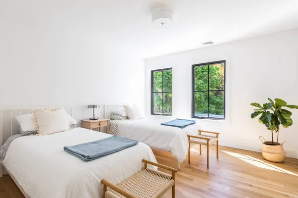 a bedroom with a bed and a potted plant