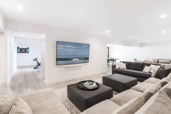 a living room with furniture and a wooden floor