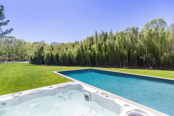 a view of a swimming pool and trees in the background
