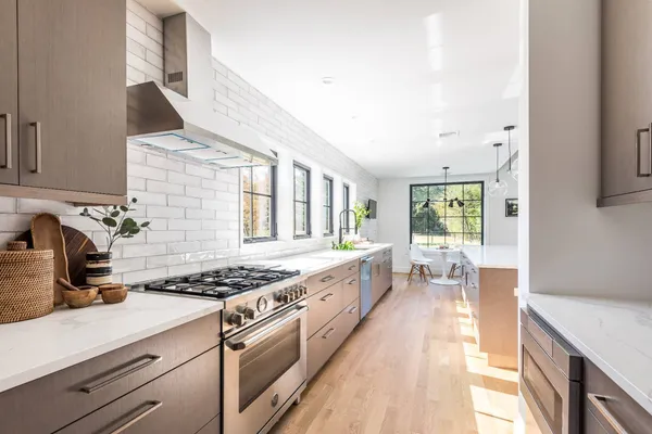 a kitchen with stainless steel appliances granite countertop a stove a sink and a refrigerator