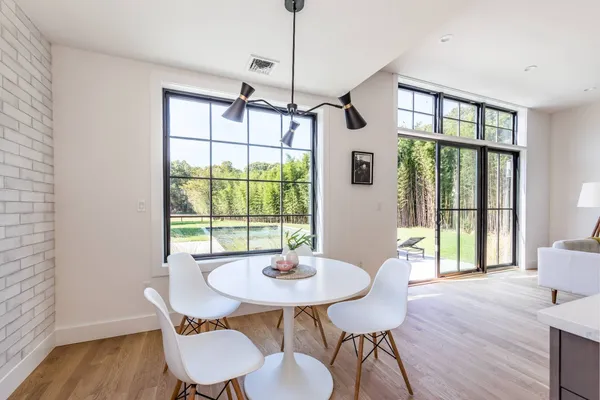 a view of a dining room with furniture window and wooden floor