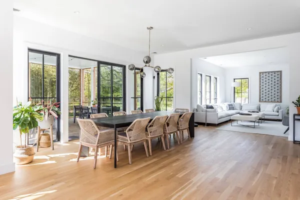 a view of a dining room with furniture window and wooden floor