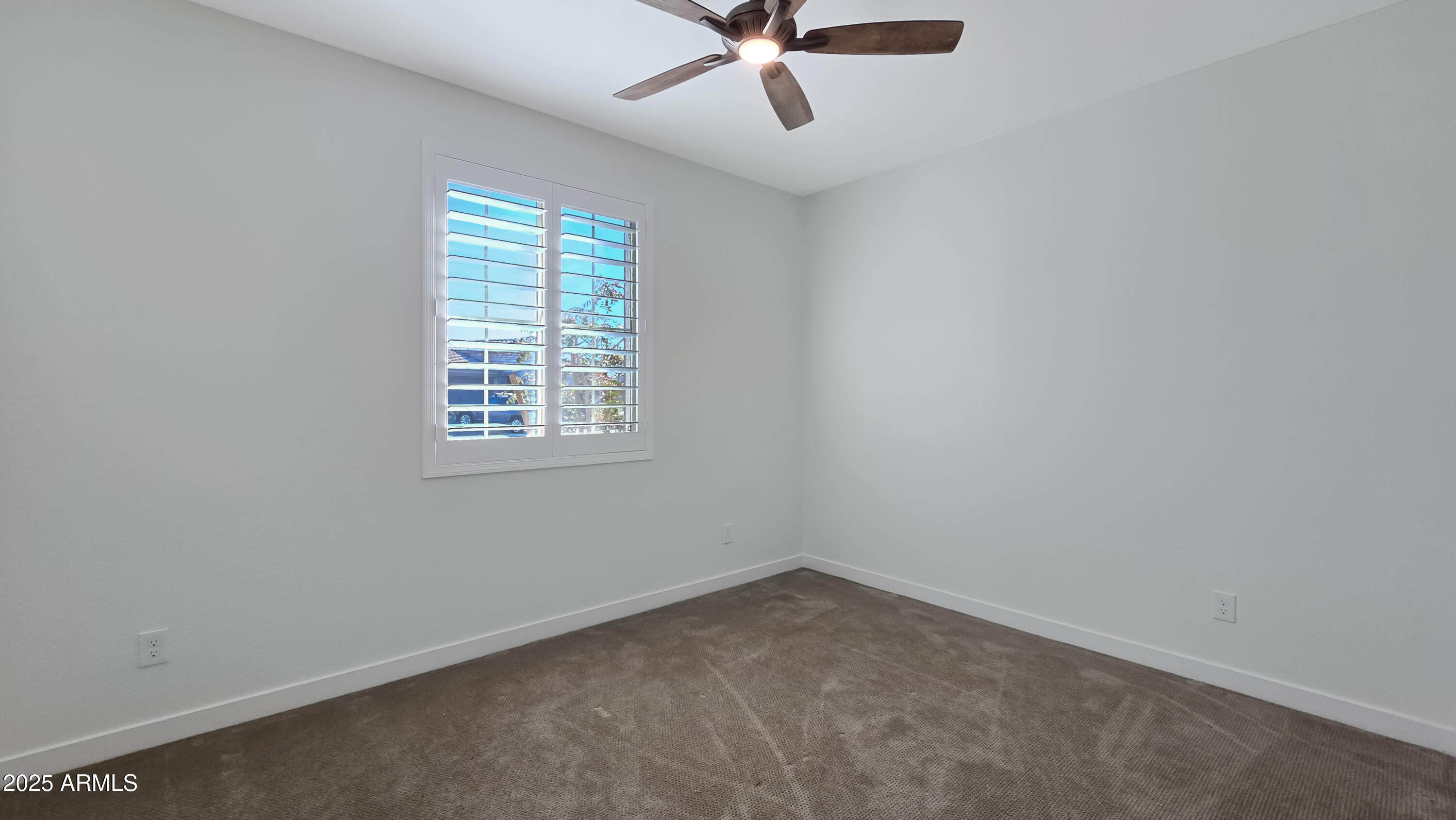 17864 West Thistle Landing Drive Goodyear, AZ 85338 - Photo 14 of 43 an empty room with a window and a fan