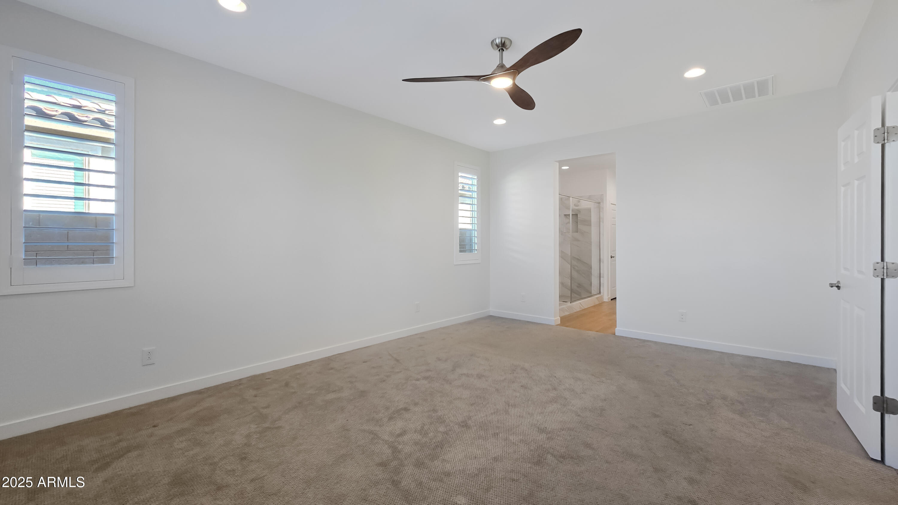 17864 West Thistle Landing Drive Goodyear, AZ 85338 - Photo 17 of 43 an empty room with closet and windows