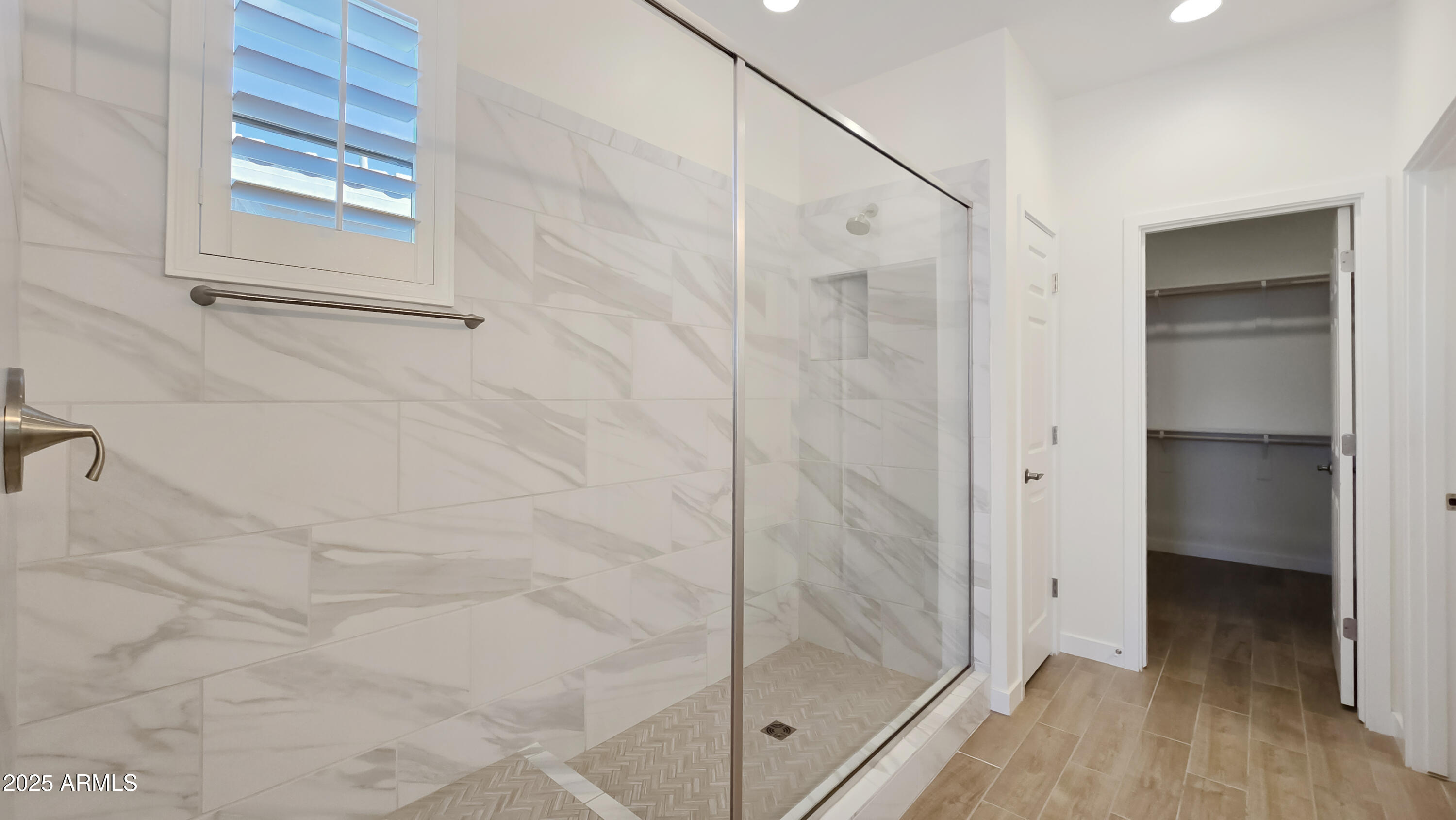 17864 West Thistle Landing Drive Goodyear, AZ 85338 - Photo 20 of 43 a bathroom with a glass shower door