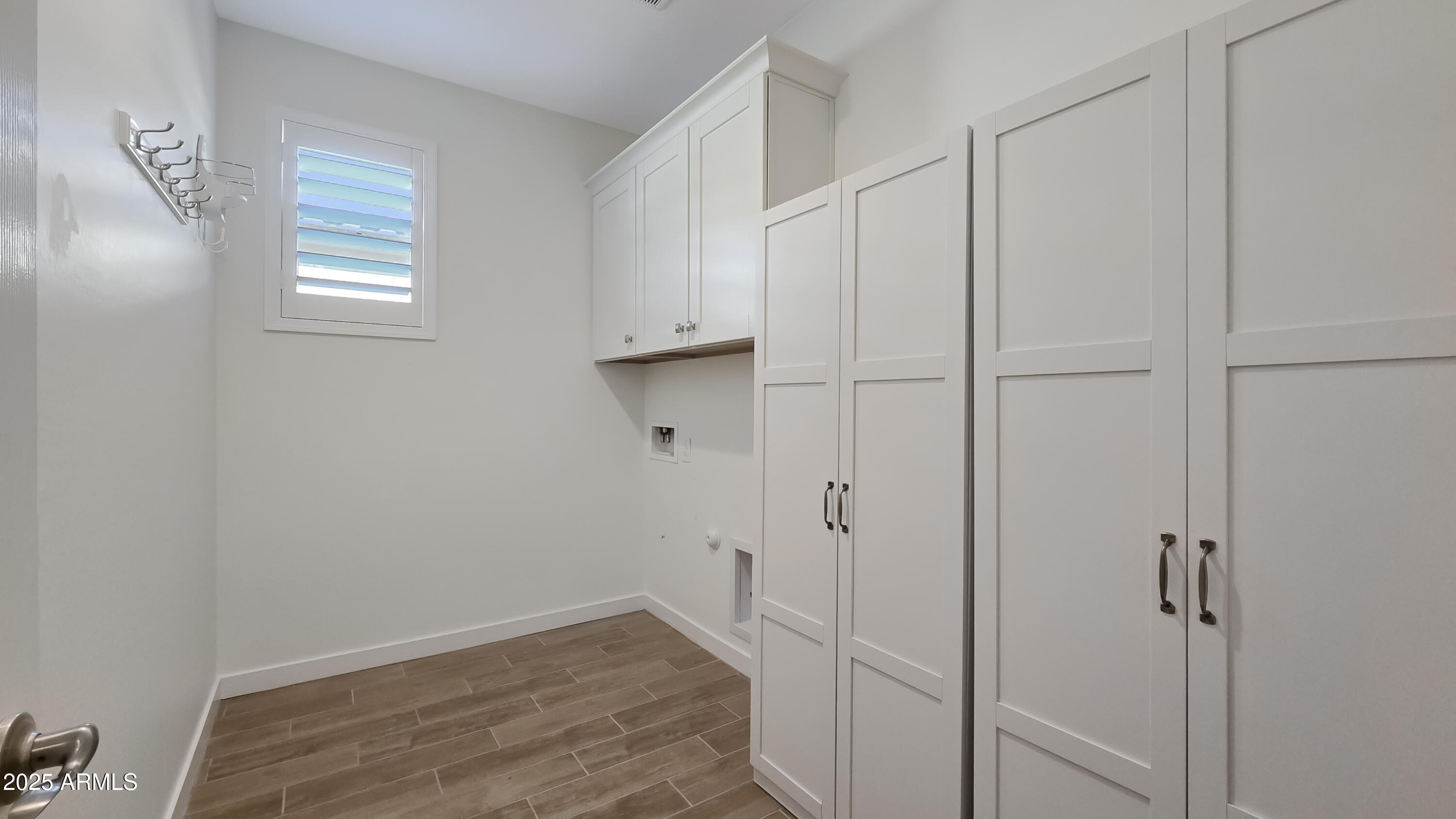 17864 West Thistle Landing Drive Goodyear, AZ 85338 - Photo 24 of 43 a view of room with hardwood floor and window