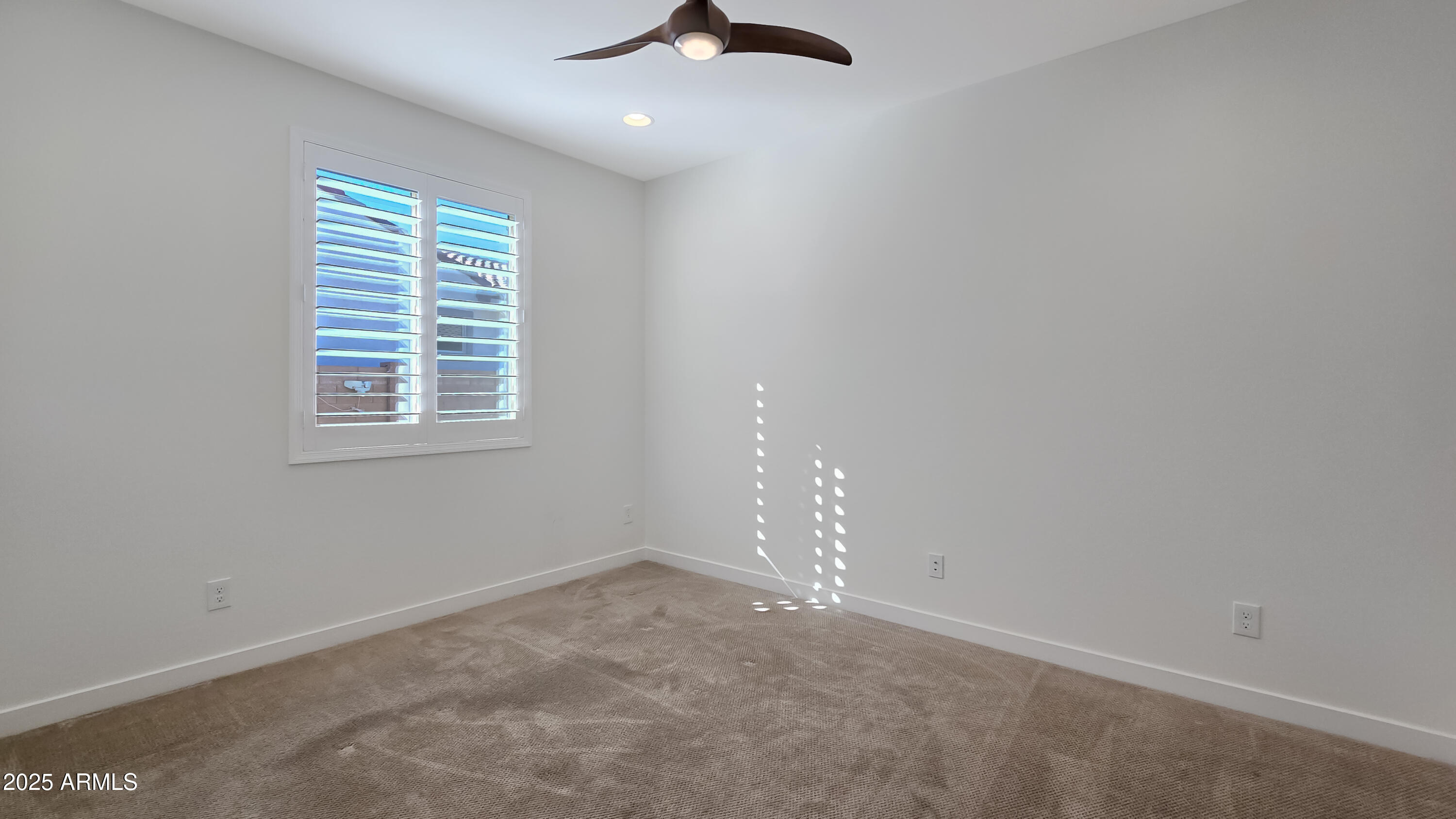 17864 West Thistle Landing Drive Goodyear, AZ 85338 - Photo 3 of 43 an empty room with a window
