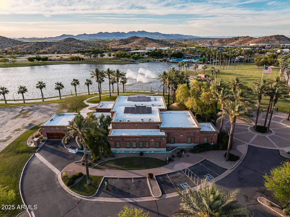 17864 West Thistle Landing Drive Goodyear, AZ 85338 - Photo 36 of 43 a view of a lake with a house in the background