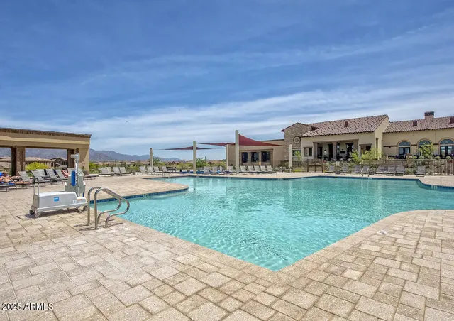 a view of a swimming pool and a back yard